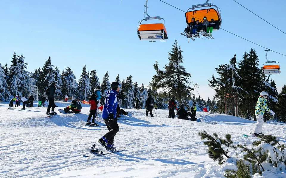 Skiers beneath a mountain chairlift