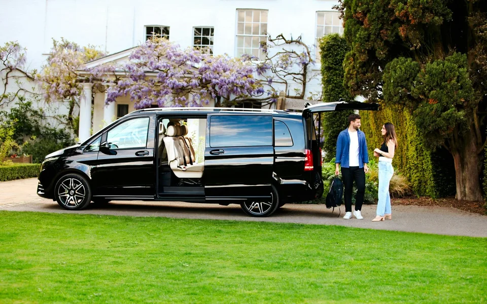 Private transfer vehicle parked outside a building