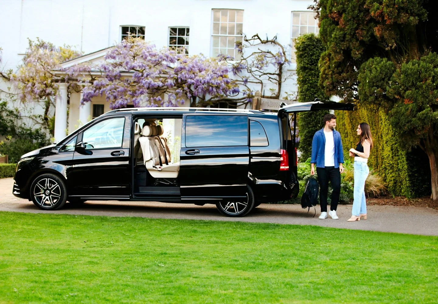 Private transfer vehicle parked outside a building