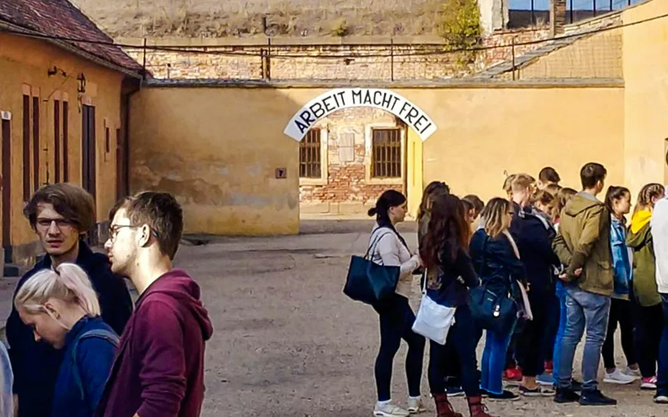 Visitors entering the Small Fortress courtyard at Terezín