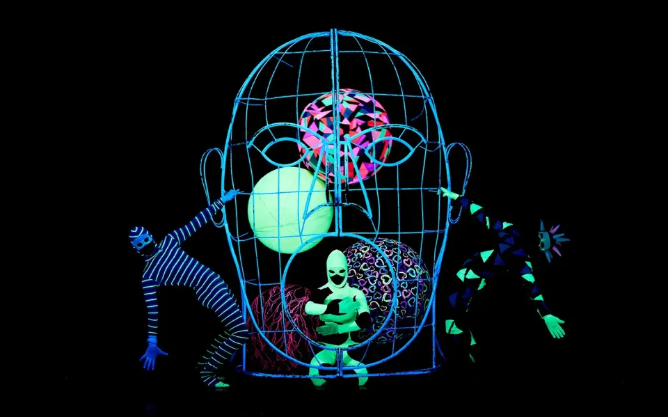Glowing stage shapes during a Prague black light performance