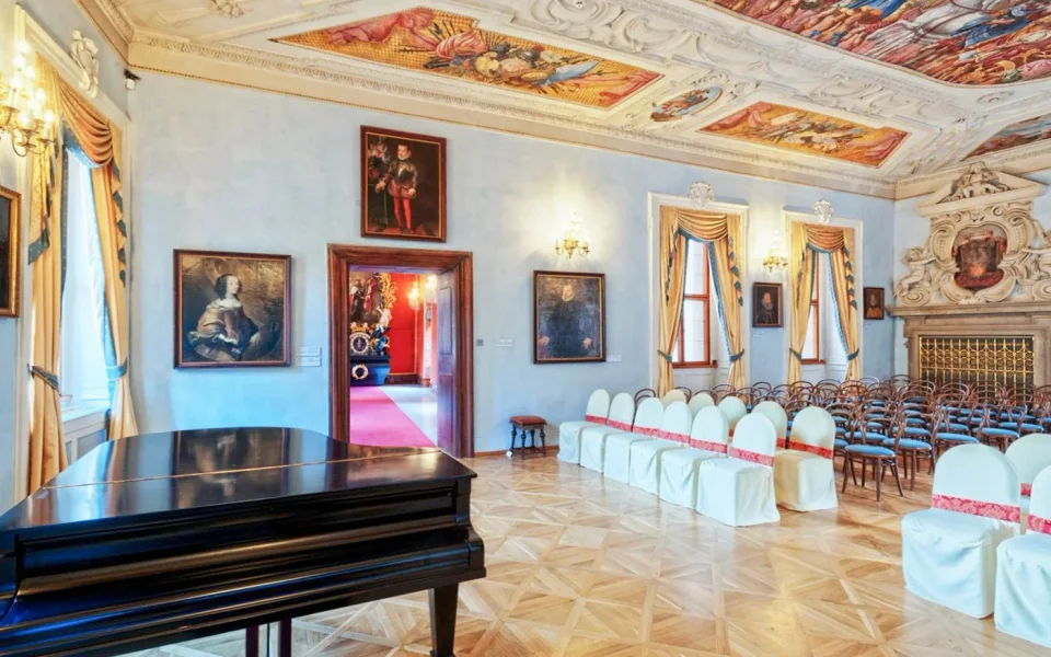 Piano and paintings in a room at Lobkowicz Palace