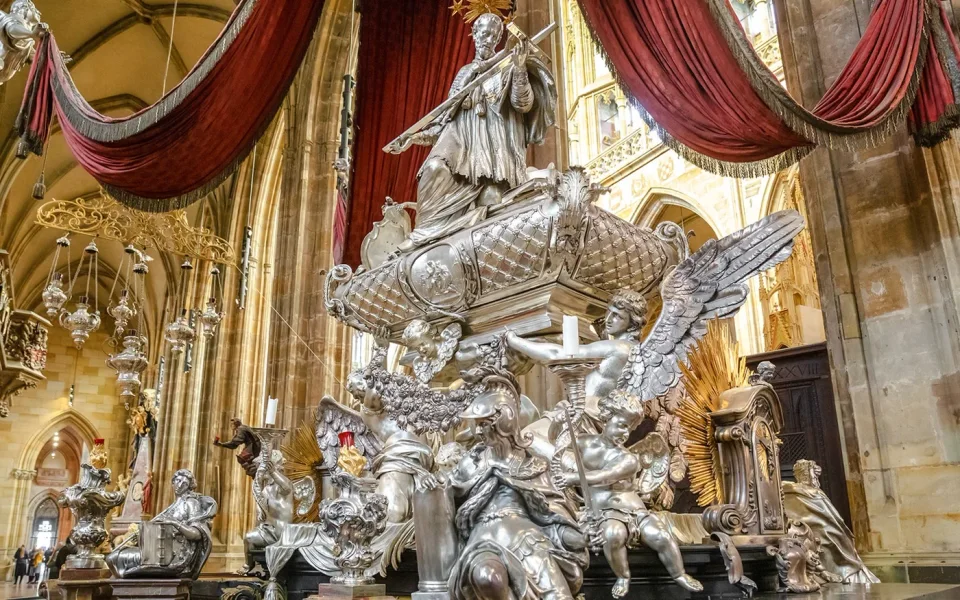 Silver monument beneath red drapery in St Vitus Cathedral
