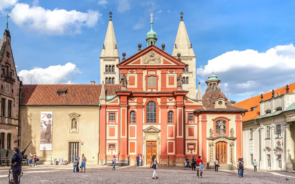 Red facade of St George’s Basilica in the Prague Castle courtyard