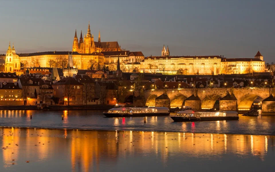 Prague Castle illuminated above the Vltava at night