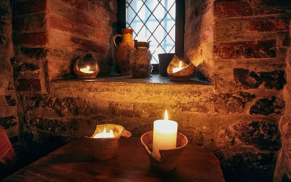 Candlelit stone interior at a Prague medieval tavern