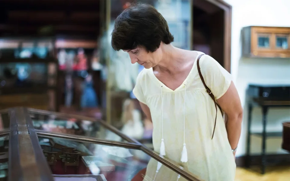 Visitor looking into a museum display case