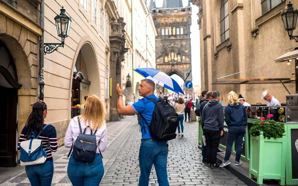 A guide leading visitors through Prague’s Old Town streets