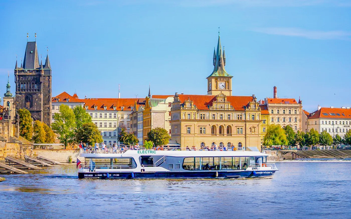 Sightseeing boat on the Vltava below Prague’s riverside buildings